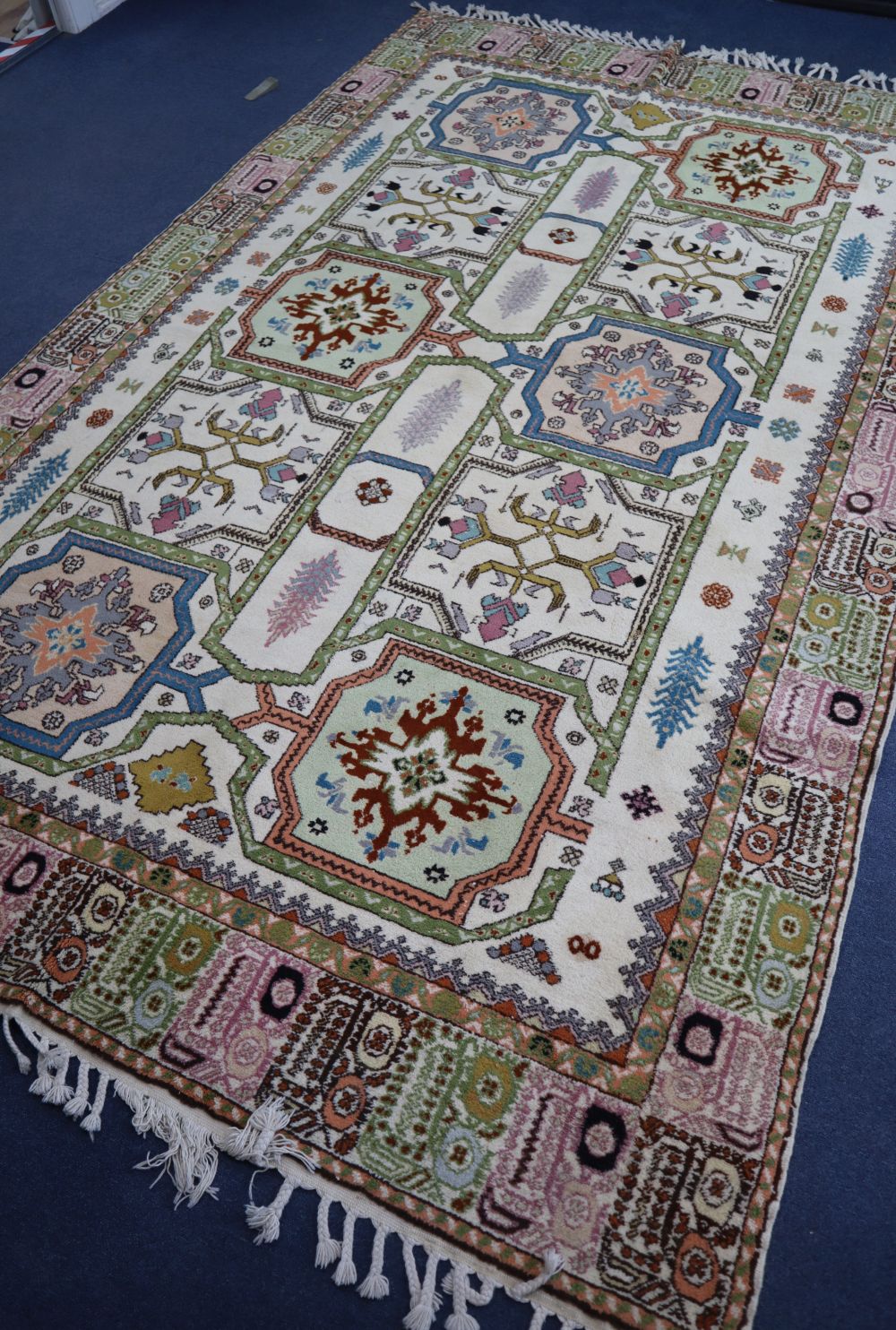 A Caucasian design ivory ground geometric rug, 310 x 195cm